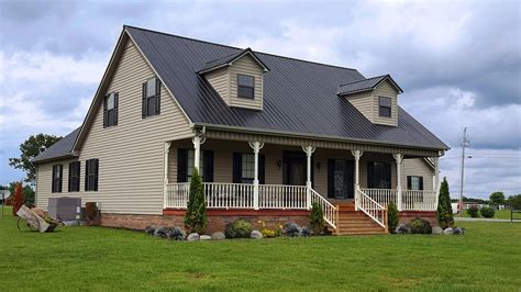 yellow house with blue metal roof|brown roof house color scheme.